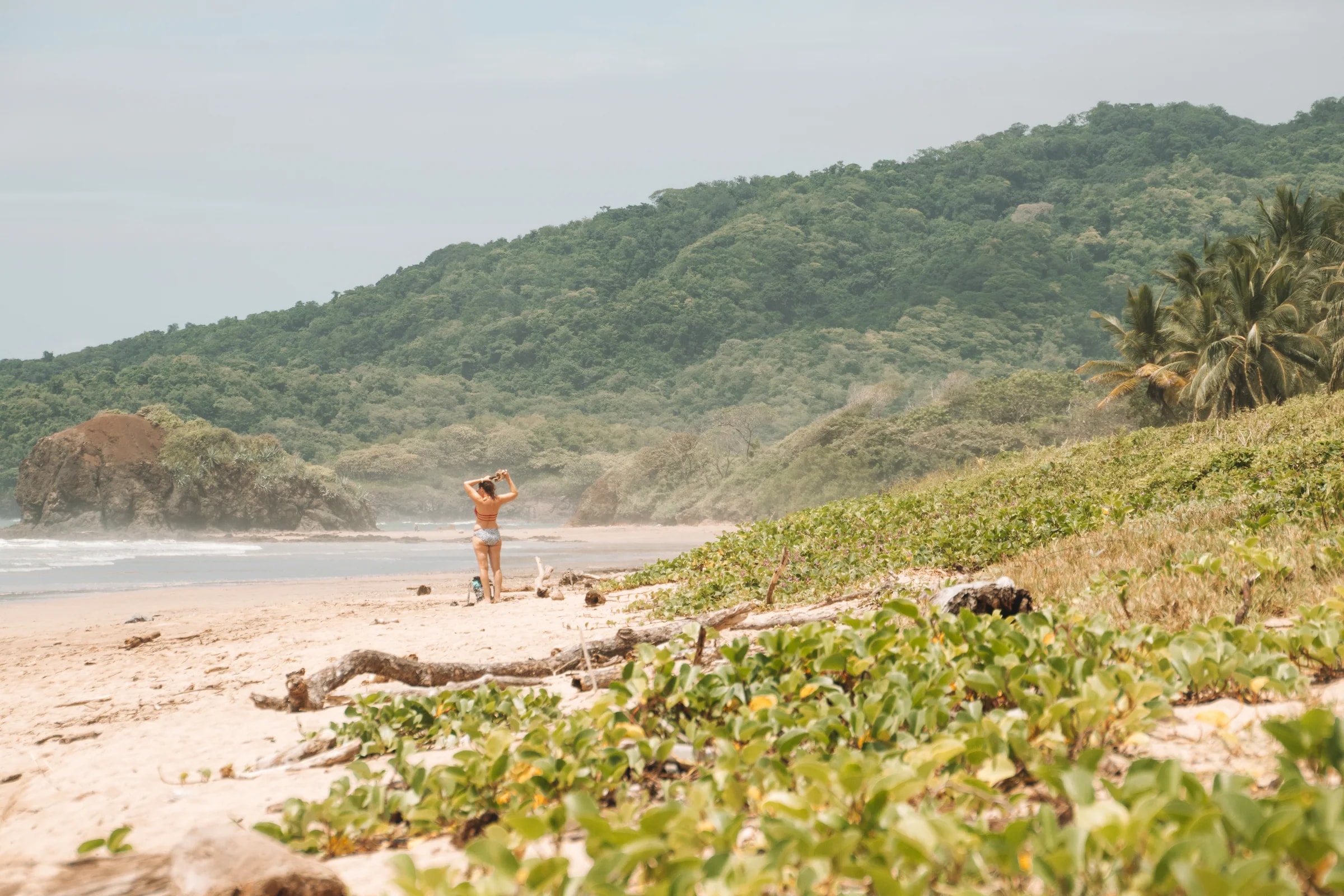 A guest walking along the shore at Playa Grande