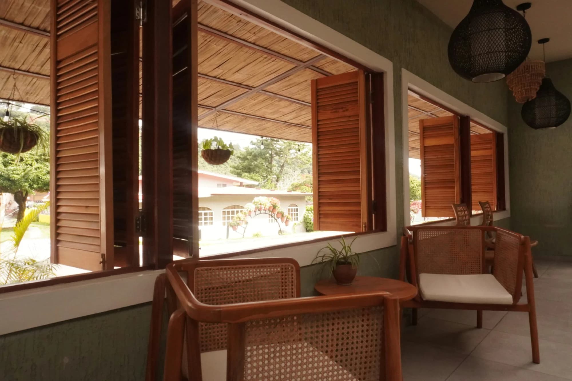 A wood desk beside open windows at ONDA Boquete