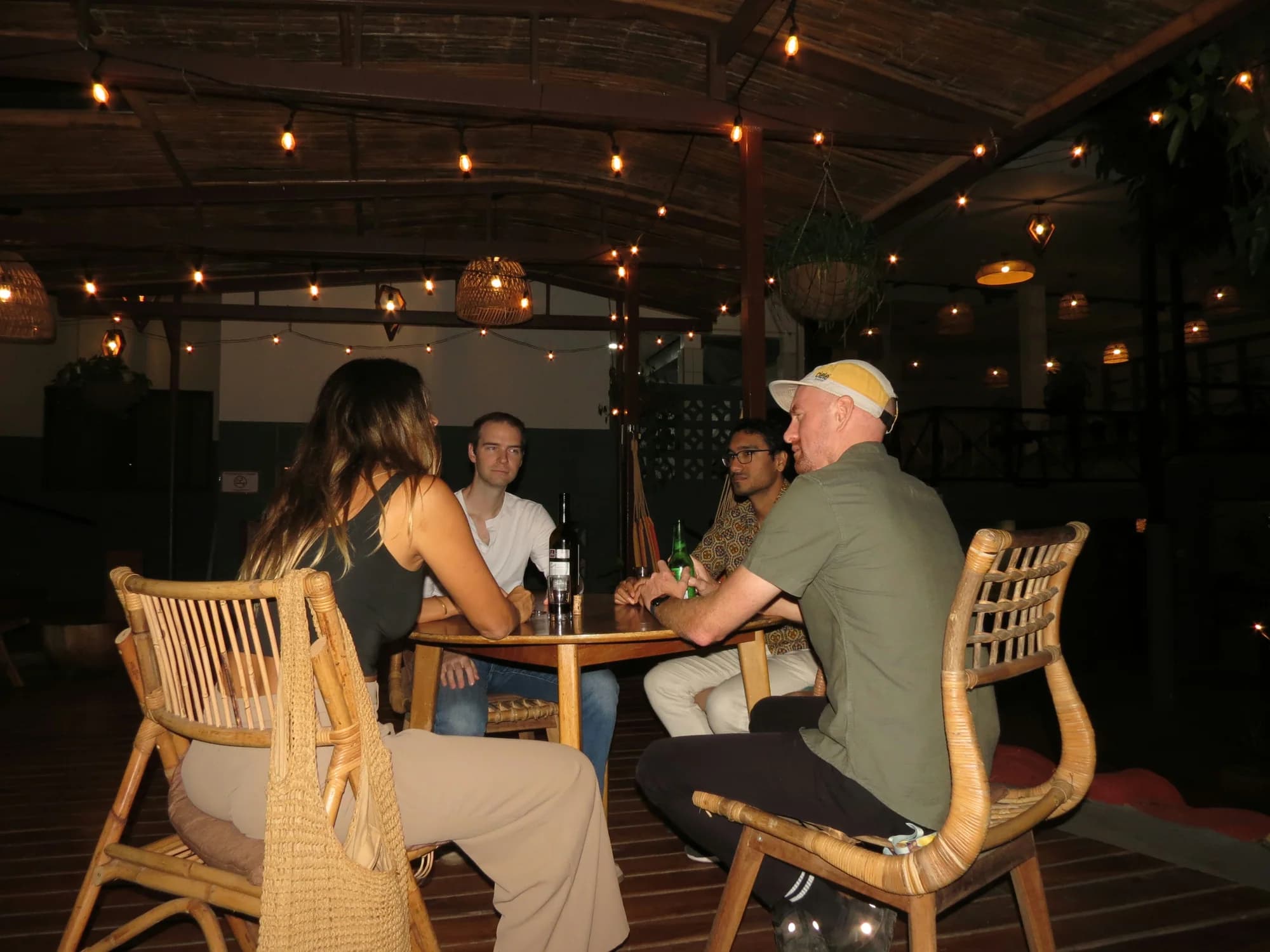 Guests talking around a table beneath the lights at ONDA Boquete