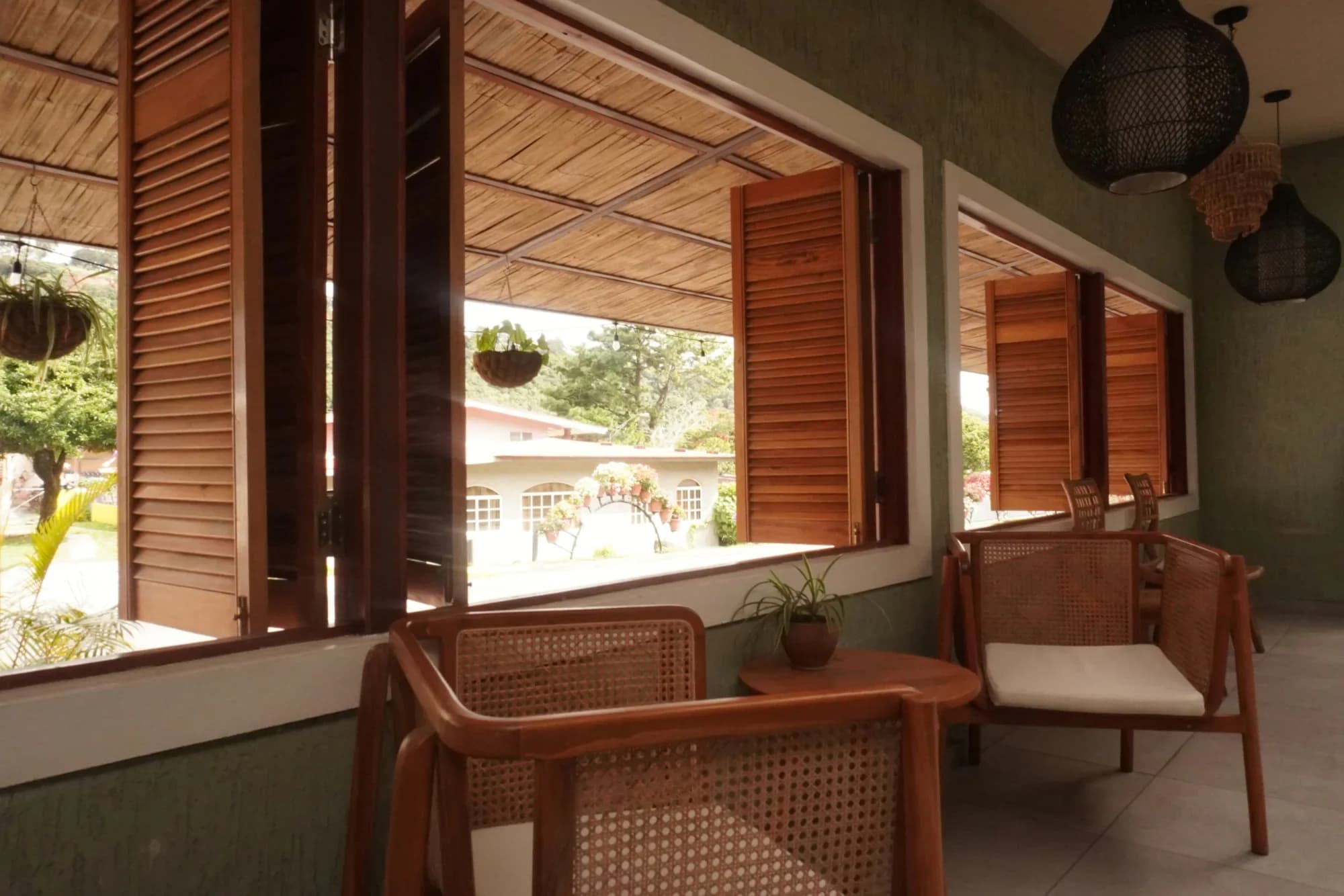 A wood desk beside open windows at ONDA Boquete