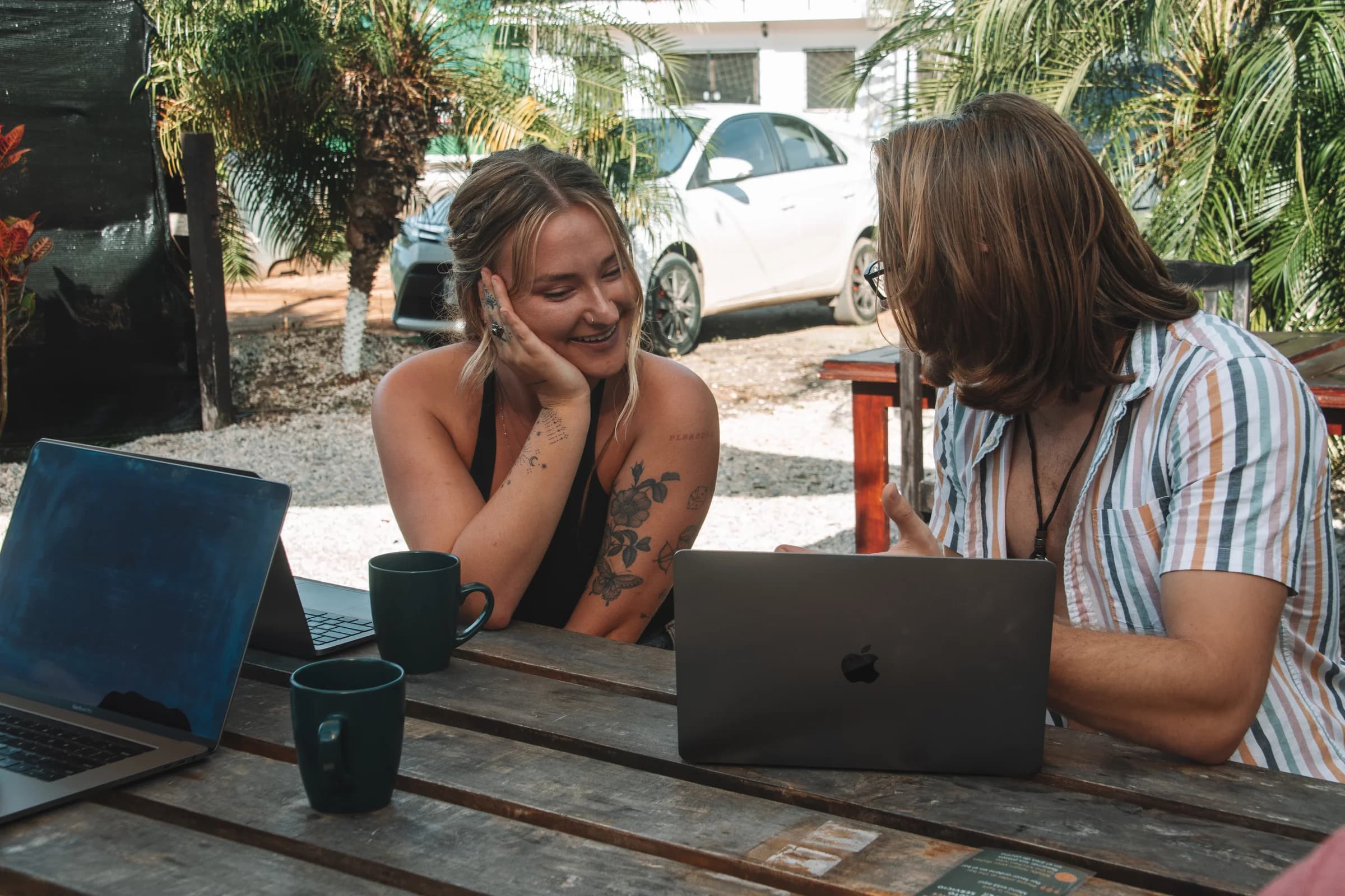 Guests working together in the bright coworking space at ONDA Playa Grande